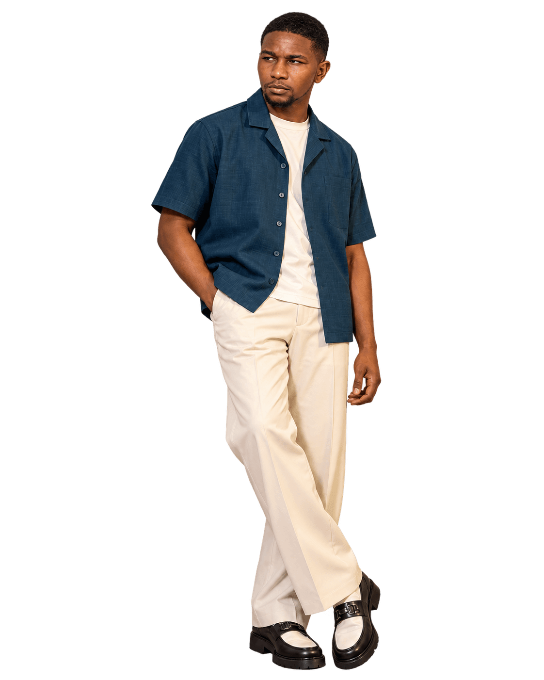 Muiyuro wearing a denim blue shirt and cream trousers
